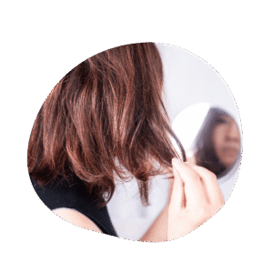 back of womans head as she touches her hair