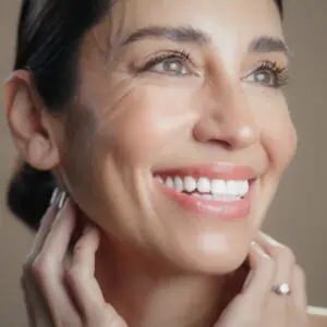 closeup photo of a woman beaming and with glowing skin