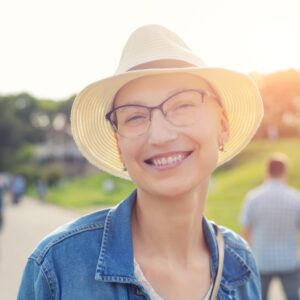 bald woman smiling in the sun